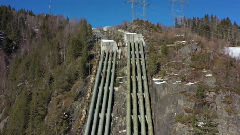 Alte-Stillgelegte-Wasserleitungen-Vom-Tunhovd-Staudamm-Zum-Wasserkraftwerk-Nore-I-In-Rodberg,-Norwegen---Luftbild-über-Massive-Rohrleitungen,-Die-Den-Hang-Hinunterkommen