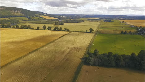 Hay-Bale-Fields-in-Scotland-on-Overcast-Midday-Aerial-View-Dolly-in