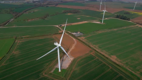 Aerial-Of-Windmills-On-Green-Field,-Lissett-Airfield-Wind-Farm-In-Yorkshire,-UK---drone-shot