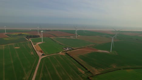 Aerial-View-Of-Wind-Turbines-In-Green-Fields-Near-Lissett,-Yorkshire,-UK---drone-shot