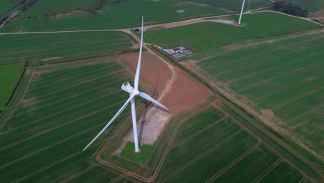 Overlooking-Lissett-airfield-rotating-wind-turbine-farm-on-agricultural-farmland-aerial-view-Yorkshire-countryside