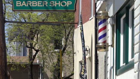 Barbershop-sign-with-barber-pole-and-adjacent-buildings