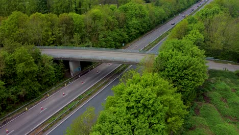 Static-drone-view-of-cars-traveling-along-the-A2-dual-carriage-way-in-Canterbury-with-orange-traffic-cones