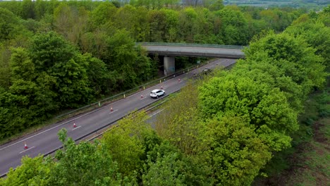 Stable-4K-static-drone-shot-of-A2-dual-carriage-way-with-cars-passing-under-a-bridge