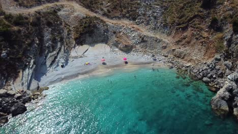 Drone-shot-of-the-Albanian-coast-in-the-Mediterranean-sea---drone-is-reversing-from-a-lonely-beach