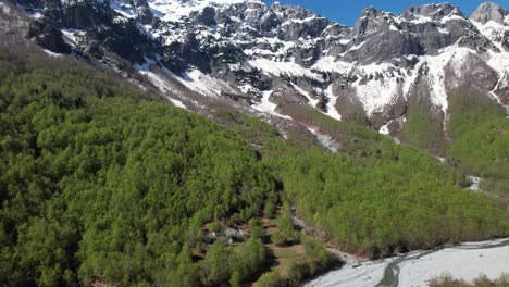 Valley-of-Valbona-with-river-streaming-from-melted-snow,-high-mountains-in-Albania