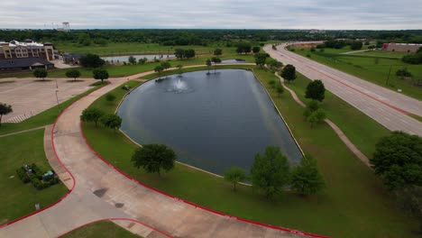 Aerial-footage-of-pond-in-front-of-Valley-Creek-Church-in-Flowermound-Texas