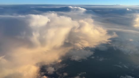 Aerial-view-of-some-cumulonimbus-clouds-taken-from-a-jet-cockpit-during-the-cruise-with-nice-colors