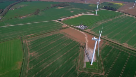 Lissett-airfield-rotating-wind-turbine-farm-on-agricultural-farmland-aerial-view-overlooking-Yorkshire-countryside