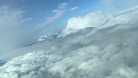Aerial-view-from-a-jet-cockpit-during-a-right-turn-overflying-clouds