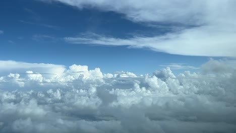 Aerial-view-from-a-jet-cockpit-while-flying-over-clouds