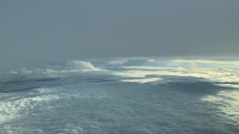 Aerial-view-from-a-cockpit-while-flying-between-layers-of-clouds-in-a-stormy-day