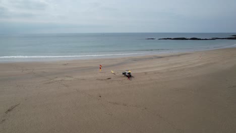lifeguard-on-Devon-beach-UK-with-dog-drone-aerial-view