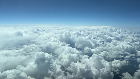 Aerial-view-from-a-cockpit-of-a-blue-sky-plenty-of-good-wheather-cumulus-and-a-deep-blue-sky