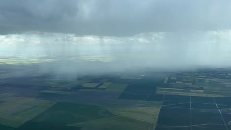 Aerial-view-of-a-big-rain-showers-near-Seville,-Spain,-taken-from-a-jet-cockpit