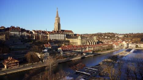 View-of-the-old-city-of-Bern-with-the-spire-of-the-gothic-minster-cathedral-on-the-skyline-over-looking-the-river-Aare