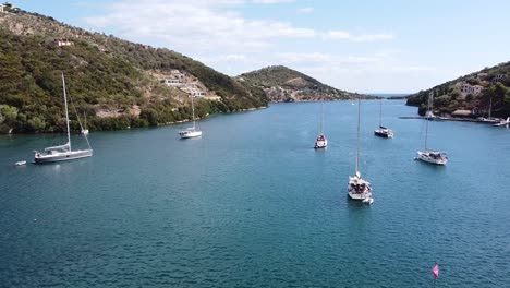 Floating-Sailboats-at-Mikros-Gialos,-Lefkada-Island,-Greece---Aerial