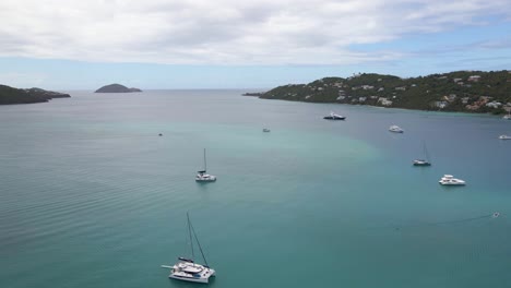 Aerial-view-of-boats-on-the-coast-of-St-Thomas-island,-USA---ascending,-drone-shot