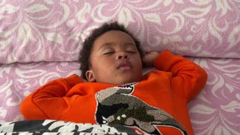 Exotic-and-cute-afro-european-two-year-old-child-sleeping-deeply-in-his-bed