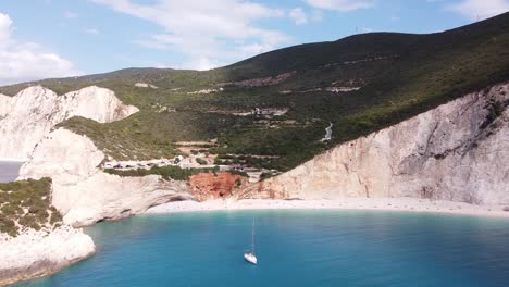 Barco-De-Lujo-En-La-Playa-De-Porto-Katsiki,-Isla-De-Lefkada,-Grecia---Antena-De-Marcha-Atrás