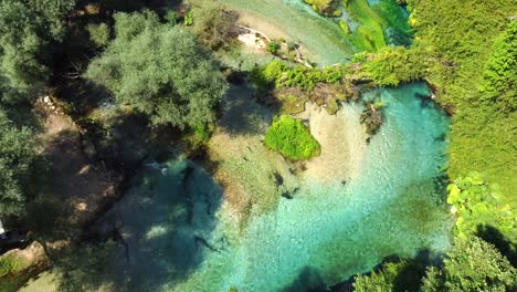 Drone-shot-of-the-Blue-Eye-in-Albania---drone-is-flying-over-the-river,-ending-at-the-actual-blue-eye,-the-river-source