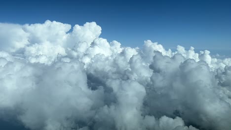 Aerial-view-from-a-jet-cockpit-overflying-a-sky-plenty-of-white-cumulus