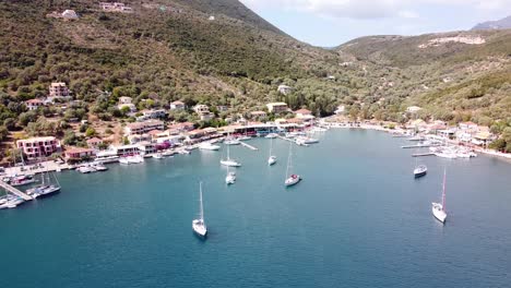 Luxury-Boats-Floating-at-Mikros-Gialos-Village,-Lefkada,-Greece---Aerial
