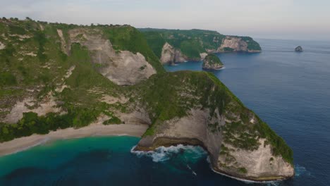 Nusa-Penida-shoreline-landscape-at-famous-Kelingking-beach,-aerial