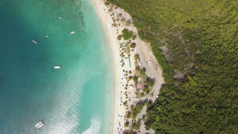 Aerial-view-rotating-over-a-white-sand-beach-and-hillside-roads-in-St-Thomas,-USA---birds-eye,-drone-shot