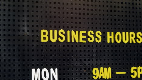 Business-opening-hours-on-a-retro-pin-board-sign