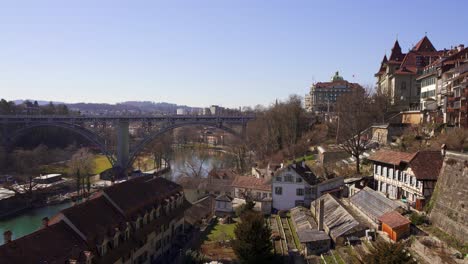 Panning-view-of-an-iron-bridge-crossing-the-River-Aare-in-Bern,-the-historic-capital-city-of-Switzerland