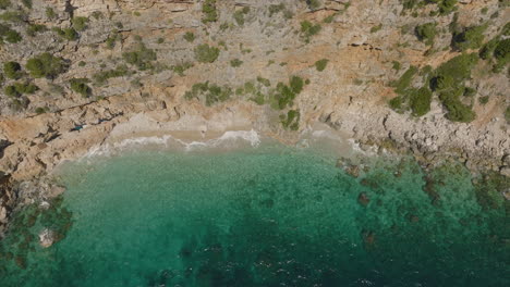 Aerial-5K-Drone-Birdseye-View-Over-Seaside-Cliffs-And-Clear-Turquoise-Water-In-Dubrovnik,-Croatia