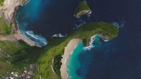 Kelingking-beach-with-tropical-steep-cliffs-on-Nusa-Penida,-T-Rex-shape-rock-formation,-aerial