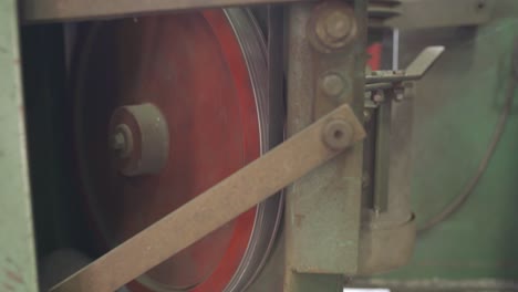 Closeup-Shot-Of-A-Bandsaw-Blade-Rotating-On-A-Industrial-Machine