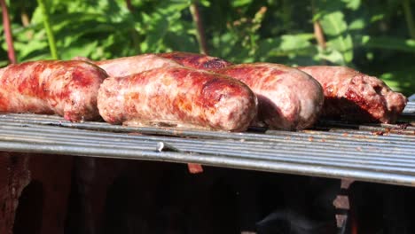 Sausages-sizzling-on-barbecue-close-up