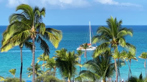 Luxury-boat-sailing-between-idyllic-Hawaiian-island-palm-tree-exotic-ocean-landscape