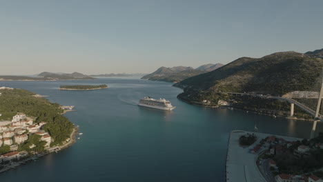 Aerial-5K-Drone-Over-Scenic-Dubrovnik-Croatia-Harbor-With-Cruise-Ship-And-Cable-Bridge