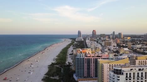 Aerial-drone-view-overlooking-hotels-at-the-south-beach,-sunrise-in-Miami,-Florida,-USA