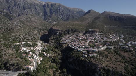 drone-video-of-plane-Dronie-receding-from-the-village-of-Nje-Maj,-Spile,-Sen-in-Himare,-on-the-Albanian-coast,-laSh8