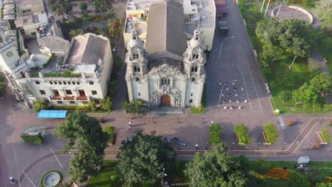Drone-video-of-church-in-Miraflores-district-of-Lima-Peru,-near-"Parque-Kennedy"-The-shot-is-recorded-while-flying-down-and-tilting-camera-up