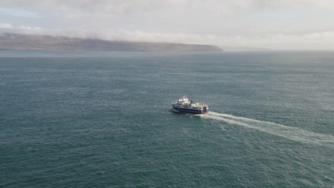 Aerial-View-Of-Ferry-Boat-With-Passengers-Cruising-In-The-Ocean-From-Sandoy-to-Streymoy-In-The-Faroe-Islands