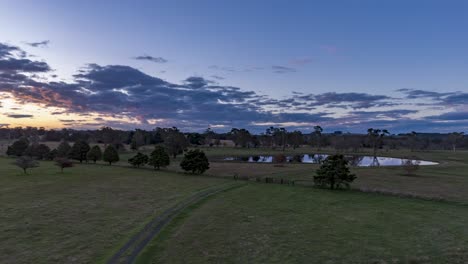 Sunset-flyover-hyperlapse-of-a-pretty-lake-on-farmland-in-Southern-NSW