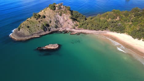 Aerial-view-of-a-secluded-beach-in-the-Coromandel,-New-Zealand