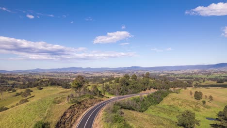 An-aerial-hyperlapse-of-a-country-highway-passing-through-farmland-in-Southern-NSW