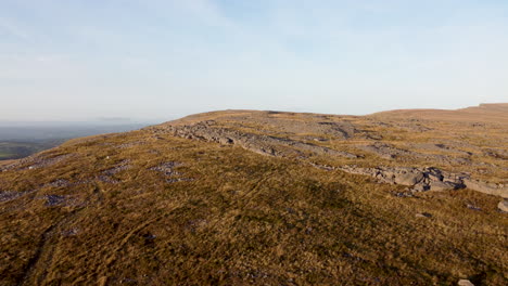 Aerial-Drone-4K-shot-Rising-Rapidly-Over-Rocky-Mountain-Landscape-with-Blue-Sky-in-Brecon-Beacons,-UK