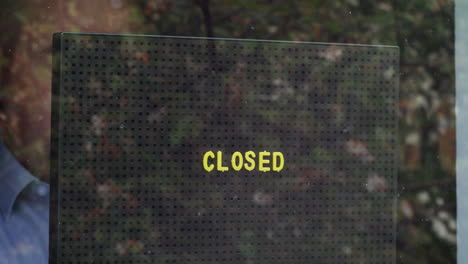 Placing-a-closed-sign-in-the-window