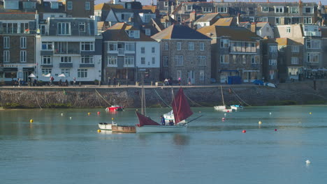 Sailors-Folding-The-Mainsail-Of-A-Dinghy-Near-The-Harbour-Of-St
