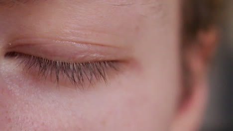 Close-up-of-a-male-human-opening-his-blue-eye-iris-pupil
