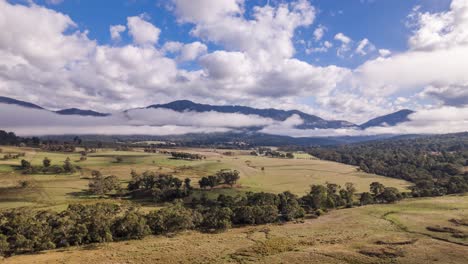 Morning-mists-give-way-to-blue-skies-over-a-horse-ranch-in-the-Snowy-Mountains,-NSW,-Australia