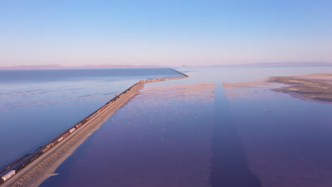 Cargo-train-crossing-railroad-causeway-over-Great-Salt-Lake-in-Utah,-USA
